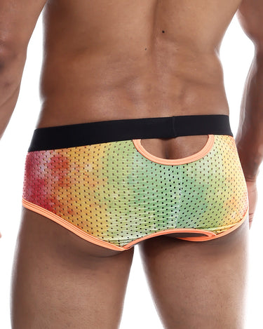 Man wearing a colorful mesh underwear on a white background